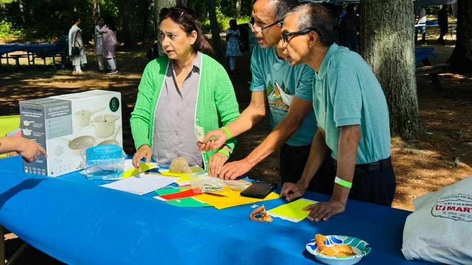 Organisers laying out raffle prizes on a table.