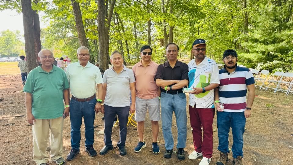 A group of members standing together for a photo at the picnic.