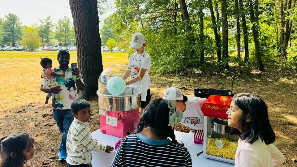 Children waiting at the cotton candy and popcorn stand.